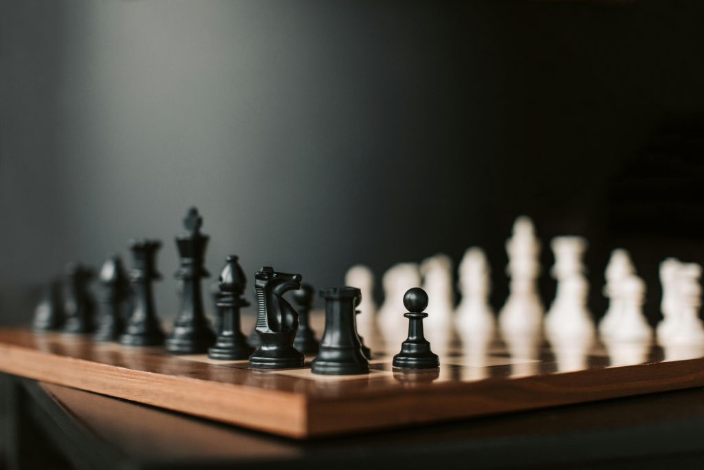Close-up of a chessboard with black pieces ready to start the game.